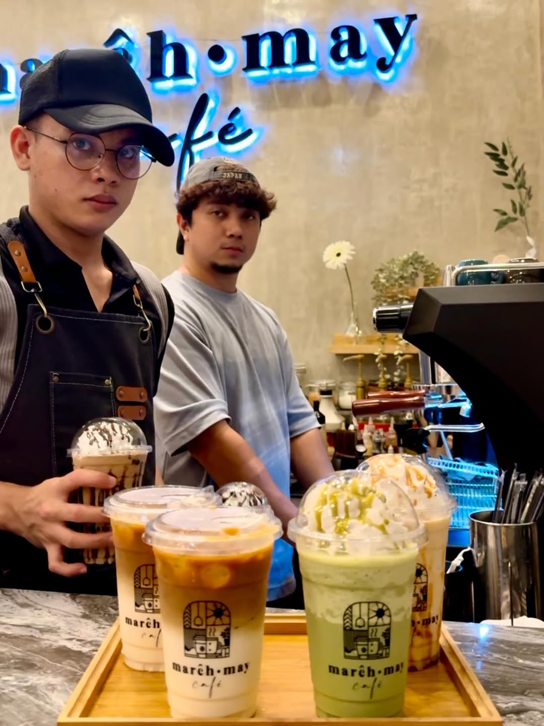 Baristas with signature March&bull;May Caf&eacute; drinks
